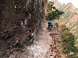 Manaslu 02 07 Dangerous Trail The trail climbs onto a ridge above huge rapids on the Buri Gandaki. Much of the trail is blasted out of vertical rock walls - steady on your feet and don't look down while you�re climbing the stone steps cut out of the mountainside. We arrived at the Gurung village of Labubesi (880m) at 15:00. A Maoist arrived at 17:30! She was a young, very mannerly, and soft-spoken young woman. She said she was collecting a 100 rupee per day tax for the Maoist Government. I dutifully paid her 1600 rupees and she gave me a receipt. She also asked for a donation. I refused, and she left.